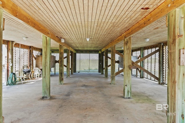 misc room featuring concrete floors and wooden ceiling