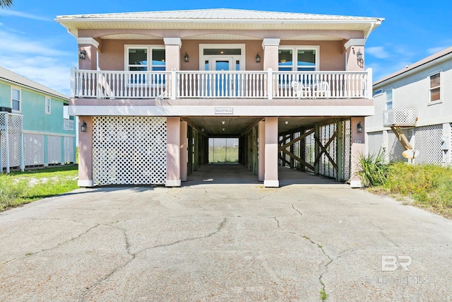 beach home featuring a porch and a carport