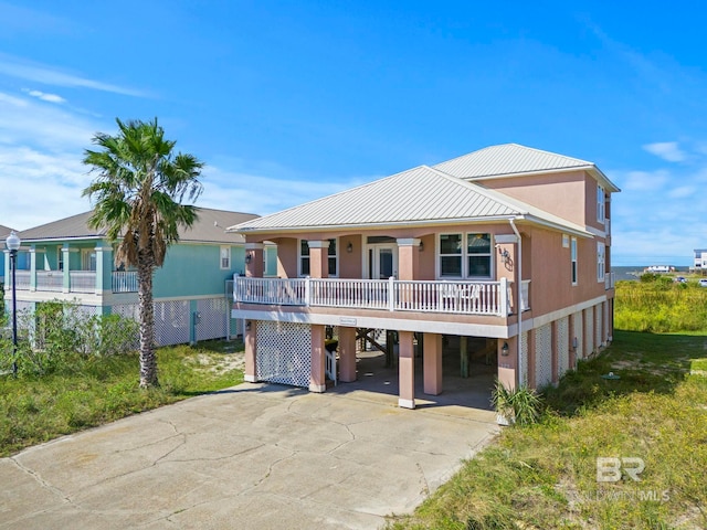 view of front of home with covered porch and a carport