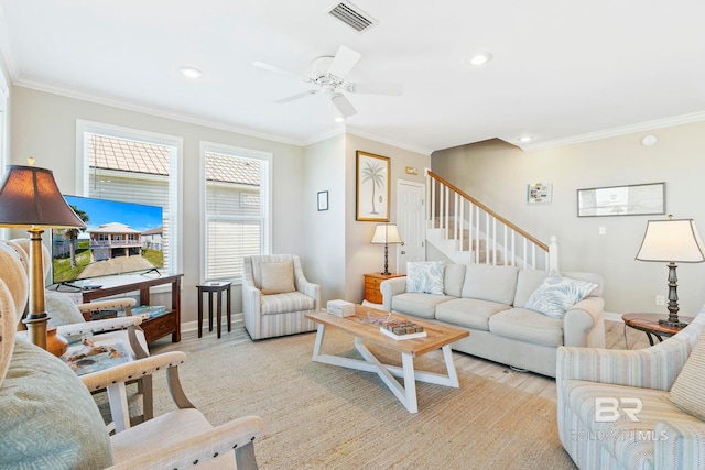 living room featuring crown molding, ceiling fan, and light hardwood / wood-style flooring