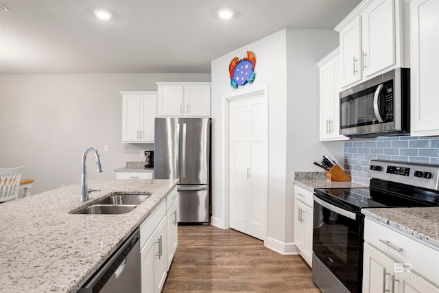 kitchen featuring light stone countertops, sink, dark hardwood / wood-style flooring, white cabinets, and appliances with stainless steel finishes