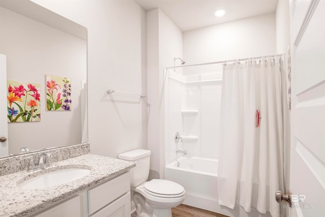 full bathroom featuring toilet, vanity, hardwood / wood-style flooring, and shower / tub combo with curtain