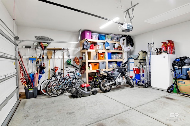 garage with white fridge and a garage door opener