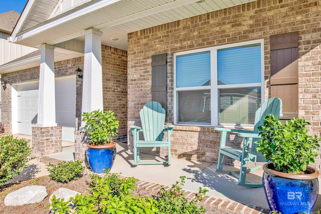 view of patio / terrace featuring a garage and covered porch