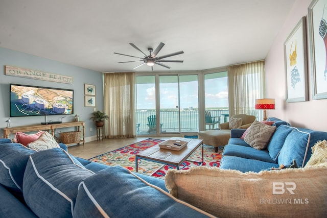 living room featuring floor to ceiling windows, light tile patterned flooring, and ceiling fan