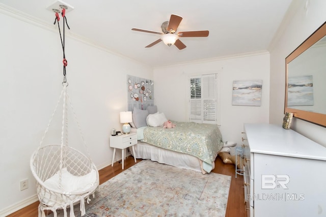 bedroom with hardwood / wood-style flooring, ceiling fan, and crown molding