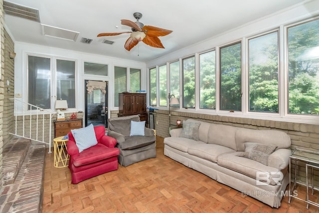 sunroom / solarium with ceiling fan and a healthy amount of sunlight