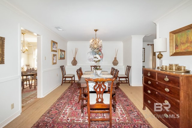 dining room featuring light hardwood / wood-style flooring and ornamental molding