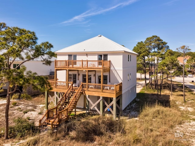 back of house with a deck, metal roof, stairs, and a balcony