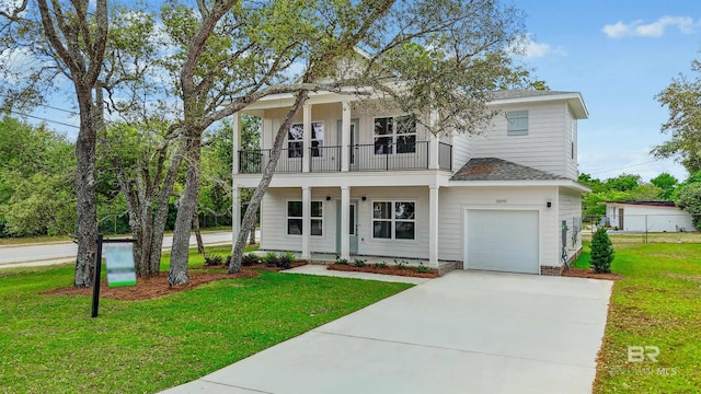 5099 Leeward Dr, Pensacola, FL 32507 - view of front of house with a balcony, a front yard, driveway, and a porch