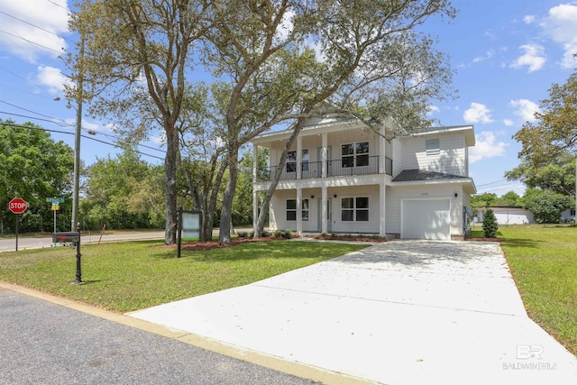 5099 Leeward Dr, Pensacola, FL 32507 - view of front of home with a front yard, concrete driveway, a balcony, a garage, and covered porch