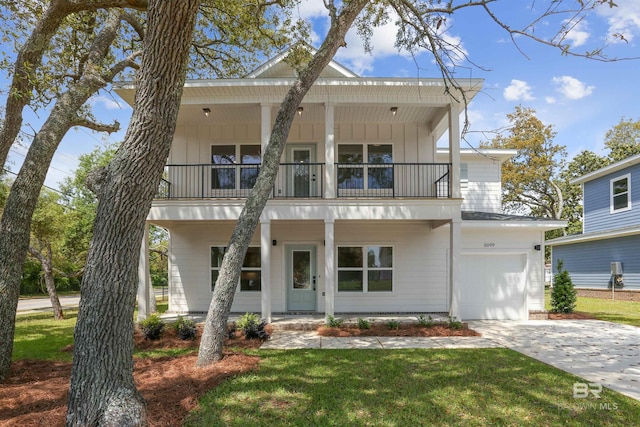 5099 Leeward Dr, Pensacola, FL 32507 - view of front of home with a balcony, covered porch, a front lawn, and driveway