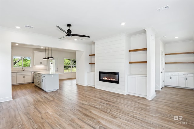 5099 Leeward Dr, Pensacola, FL 32507 - unfurnished living room with ceiling fan, recessed lighting, a large fireplace, a sink, and ornamental molding