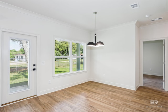 5099 Leeward Dr, Pensacola, FL 32507 - unfurnished dining area with ornamental molding, light wood-style flooring, plenty of natural light, and baseboards