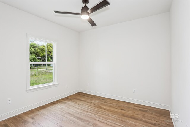 5099 Leeward Dr, Pensacola, FL 32507 - empty room with wood finished floors, baseboards, and ceiling fan