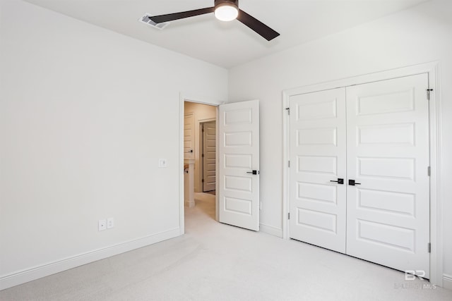 5099 Leeward Dr, Pensacola, FL 32507 - unfurnished bedroom featuring light carpet, a closet, baseboards, and a ceiling fan