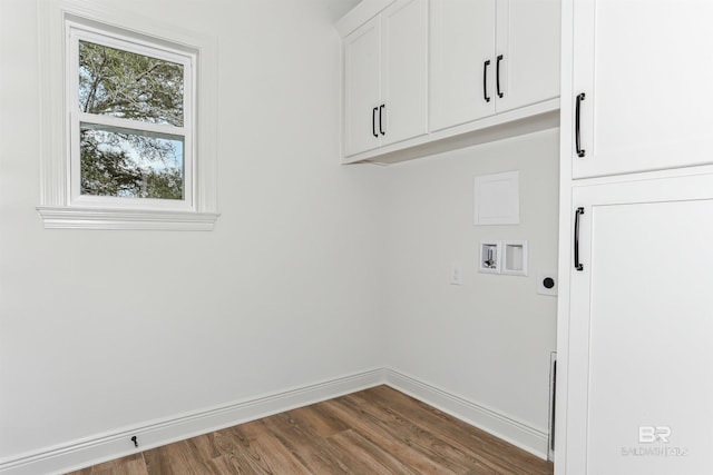 5099 Leeward Dr, Pensacola, FL 32507 - washroom featuring cabinet space, wood finished floors, baseboards, and washer hookup