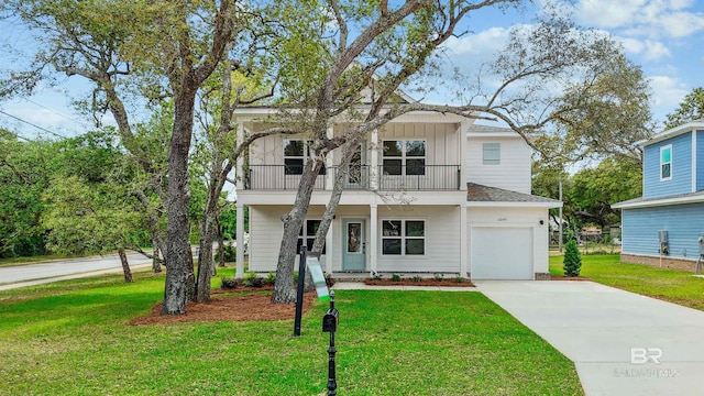 5099 Leeward Dr, Pensacola, FL 32507 - view of front of property with a balcony, concrete driveway, a front yard, and board and batten siding