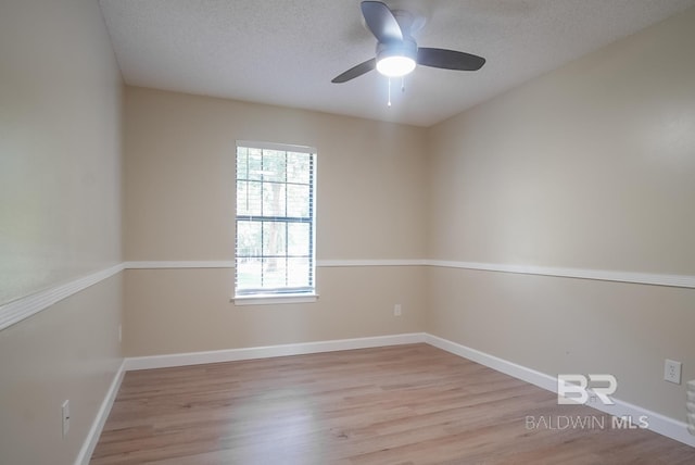 unfurnished room with ceiling fan, light hardwood / wood-style flooring, and a textured ceiling