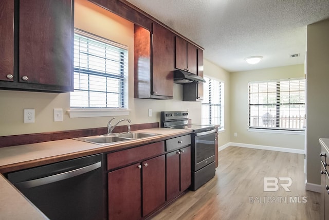 kitchen with sink, stainless steel appliances, dark brown cabinetry, a textured ceiling, and light wood-type flooring