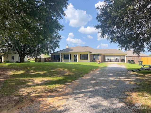 ranch-style home with a front lawn