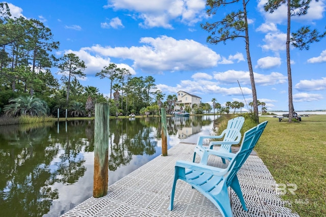 view of dock with a water view and a lawn