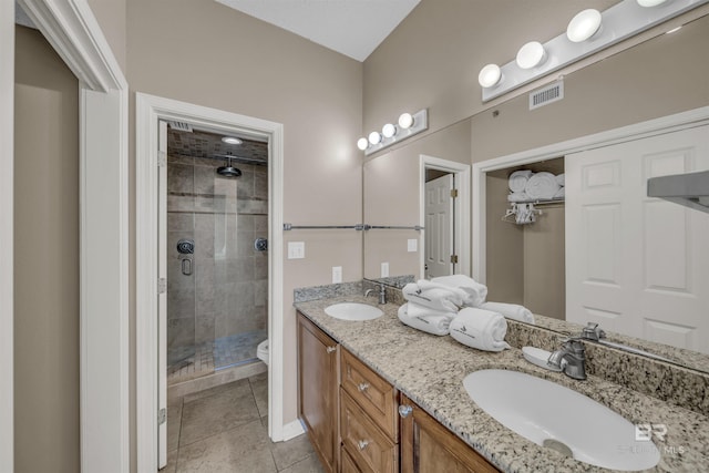 bathroom with visible vents, a shower stall, toilet, and a sink