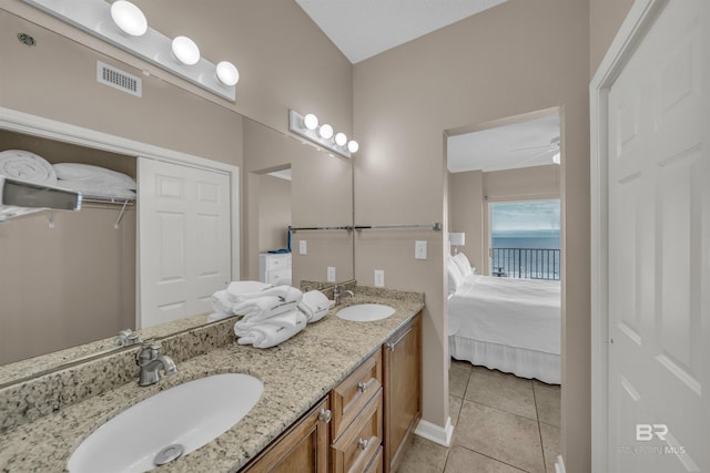 full bath featuring double vanity, connected bathroom, visible vents, and a sink