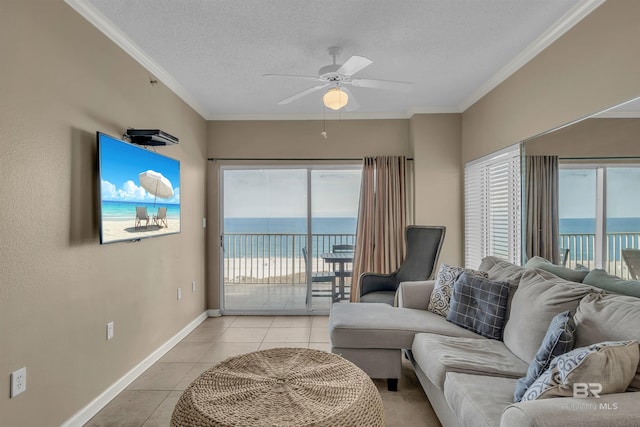 living area featuring crown molding, light tile patterned floors, a water view, and ceiling fan