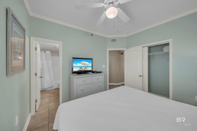 bedroom featuring visible vents, ornamental molding, a ceiling fan, a closet, and light tile patterned flooring