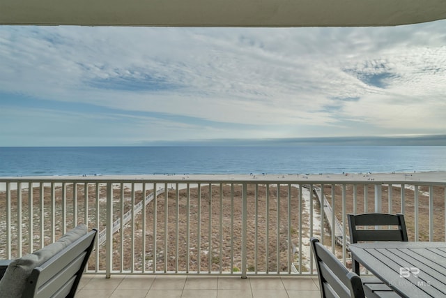 exterior space featuring a water view and a beach view