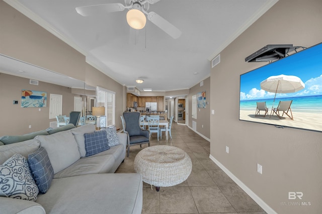 living area featuring visible vents, ornamental molding, light tile patterned floors, baseboards, and ceiling fan