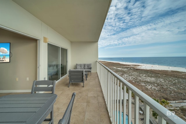 balcony with a water view and a beach view