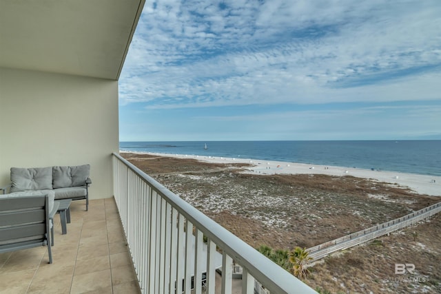 balcony featuring a water view and a view of the beach