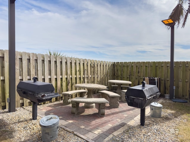 view of patio featuring area for grilling and fence