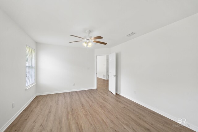 16063 Mansion St, Foley, AL 36535 - spare room with light wood-type flooring, a ceiling fan, and baseboards