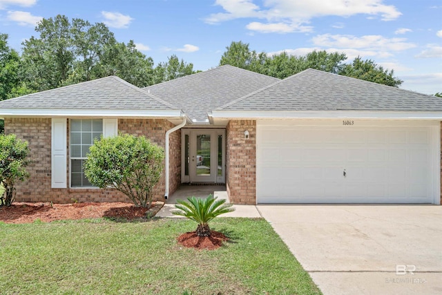 16063 Mansion St, Foley, AL 36535 - single story home with roof with shingles, a garage, brick siding, concrete driveway, and a front yard