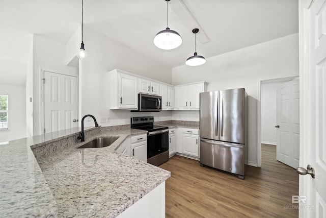 16063 Mansion St, Foley, AL 36535 - kitchen with appliances with stainless steel finishes, a sink, a peninsula, white cabinetry, and light stone counters