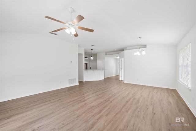 16063 Mansion St, Foley, AL 36535 - unfurnished living room featuring vaulted ceiling, a chandelier, light wood finished floors, ceiling fan, and baseboards