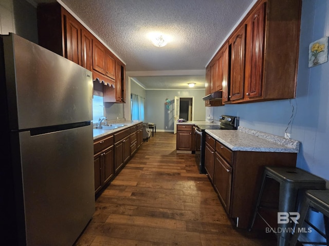 31398 Brady Rd, Robertsdale, AL 36567 - kitchen featuring dark wood finished floors, appliances with stainless steel finishes, light countertops, under cabinet range hood, and a sink