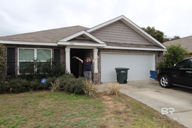 view of front of home with a garage and a front yard