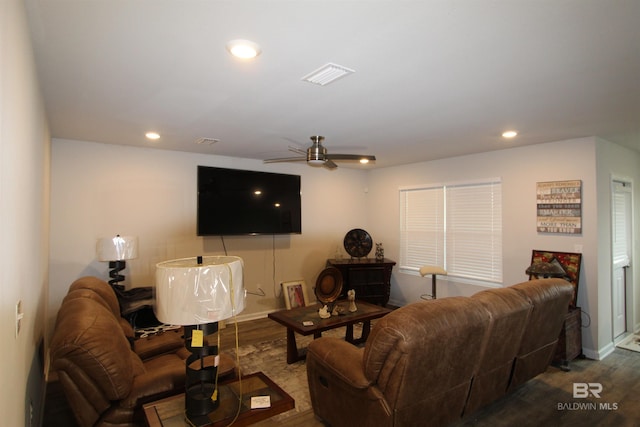 living room featuring hardwood / wood-style floors and ceiling fan