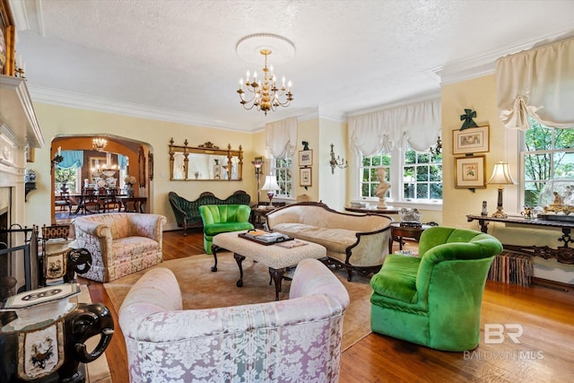 living room with hardwood / wood-style flooring, a notable chandelier, and a textured ceiling