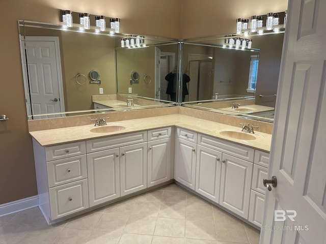 bathroom featuring tile patterned flooring, vanity, and walk in shower