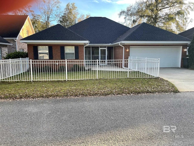 single story home featuring a garage and a front lawn