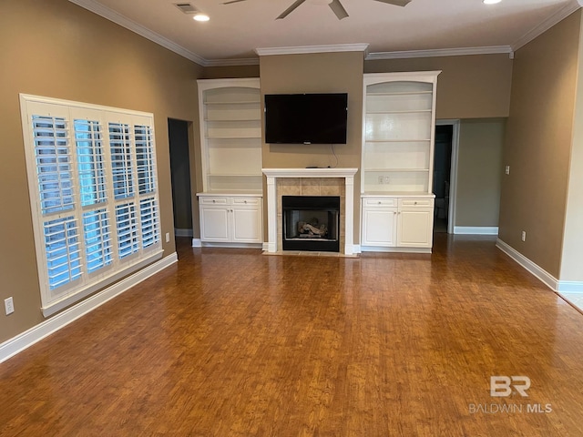 unfurnished living room featuring hardwood / wood-style flooring, ceiling fan, crown molding, and a fireplace