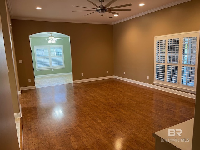 spare room featuring ceiling fan, hardwood / wood-style floors, and ornamental molding