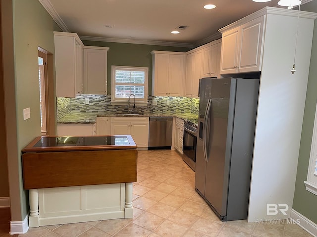 kitchen featuring decorative backsplash, appliances with stainless steel finishes, crown molding, sink, and white cabinets