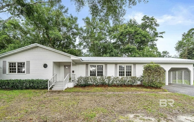 ranch-style house featuring a carport