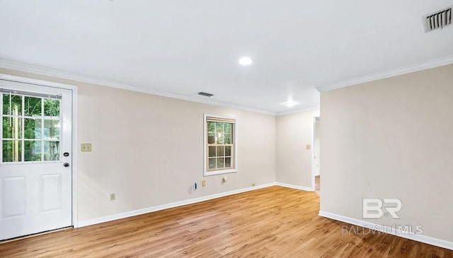 unfurnished room featuring crown molding and light hardwood / wood-style flooring